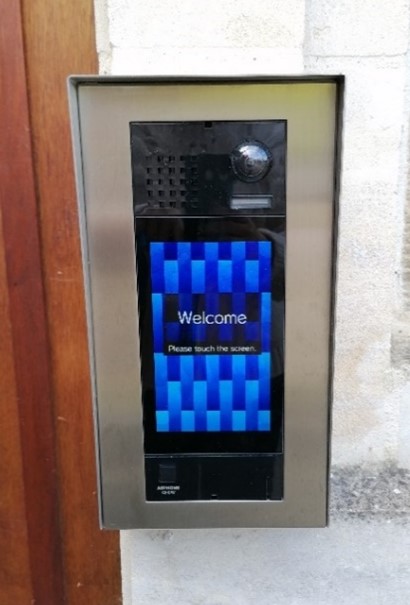 Touch-screen intercom system showing welcome screen